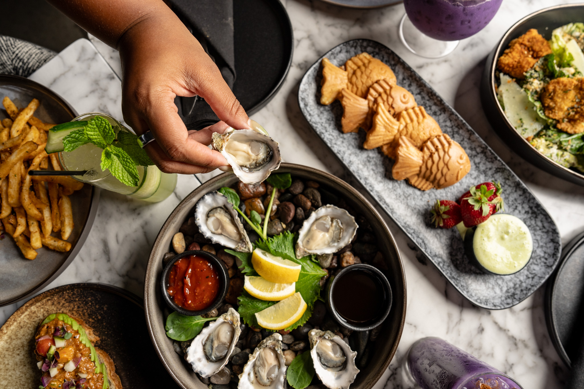 Brunch spread at Cherryfish, oysters, fries, taiyaki, katsu caesar, and cocktails
