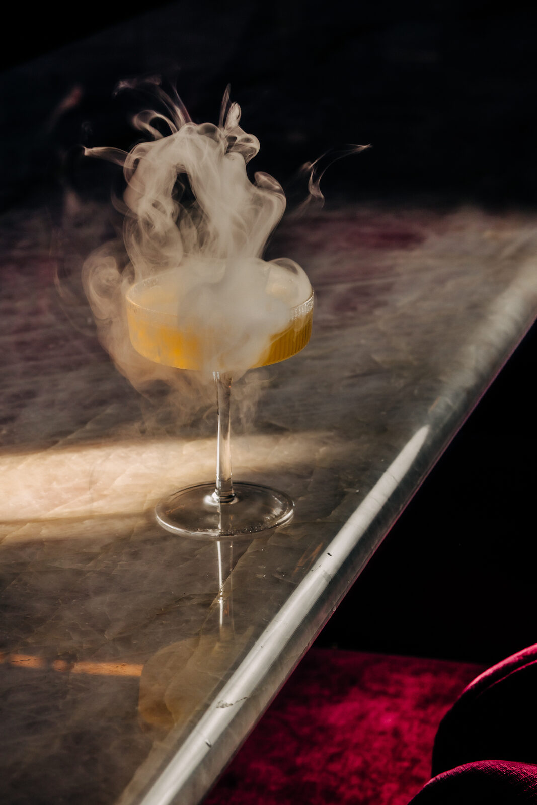 Smoky craft cocktail in coupe glass at the Cherryfish bar, Pacific Beach San Diego